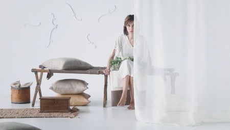 Femme assise derrire un rideau en lin blanc